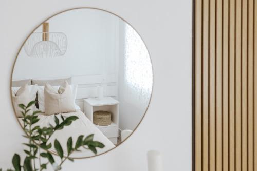 a mirror reflecting a bedroom with a bed and pillows at Casa da Sereia in Leiria