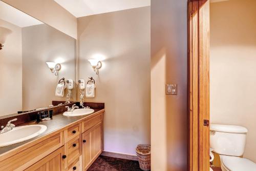 a bathroom with a sink and a toilet and a mirror at River Run Village by Keystone Resort in Keystone