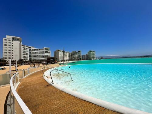 une grande piscine sur une plage avec des bâtiments dans l'établissement Dpto en Resort Laguna del Mar frente al mar 2D2B, à La Serena