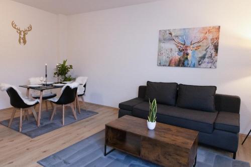 a living room with a couch and a table at Apartment Sängerstadt Flat Peter in Finsterwalde