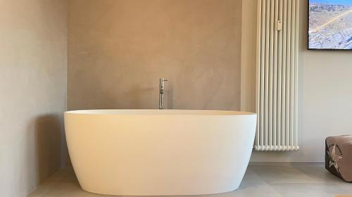 a white bath tub in a room with a radiator at Mediceo 42 in Pisa