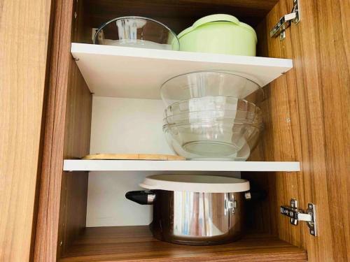 a cupboard with a pot and a mixer in it at Appartement 6 personnes les terrasses d isola2000 in Isola