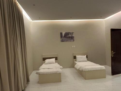 Ένα ή περισσότερα κρεβάτια σε δωμάτιο στο شقق نور سين