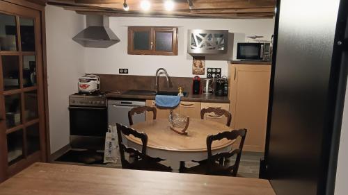 a small kitchen with a table and a sink at Gite de charme in Sommery