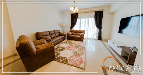 a living room with two leather couches and a television at 33 شارع العراق المهندسين in Cairo