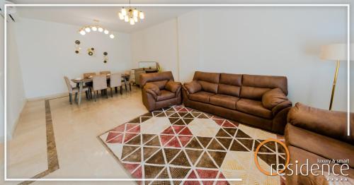 a living room with couches and a dining room at 33 شارع العراق المهندسين in Cairo