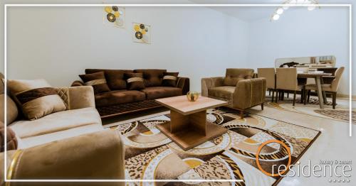 a living room with couches and a dining room at 33 شارع العراق المهندسين in Cairo