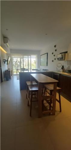 a kitchen with a table and chairs in a room at Amazing 2 bedroom condo in Golden Zone steps away from the ocean in Bucerías