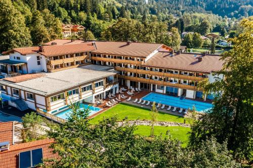 an aerial view of a resort with a swimming pool at Das Bayrischzell Familotel Oberbayern in Bayrischzell