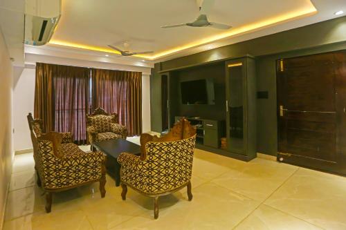 a dining room with a table and chairs and a television at Botcha Convection in Visakhapatnam
