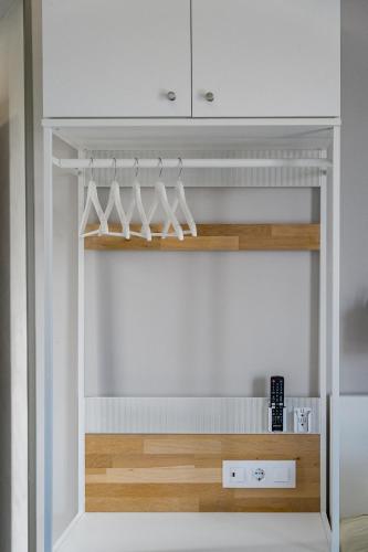 a closet with white cabinets and wooden shelves at Villa Casa Gavion in Los Menores