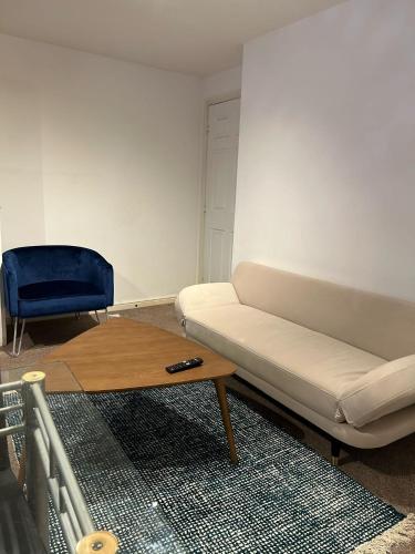a living room with a couch and a coffee table at Cosy 2 Bedroom Apartment with Parking by Cloud Suites in Manchester