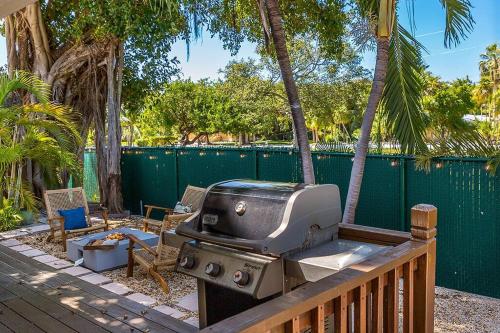 a grill sitting on a deck next to a fence at Paradise Palms - Movie Theater - Hot Tub - Pool - Arcade - Boat & RV Parking in Marathon