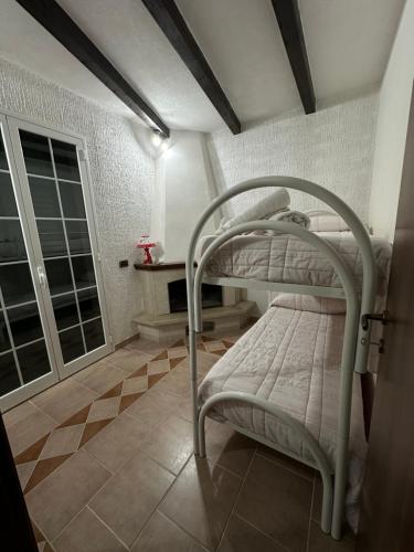 a bedroom with two bunk beds and a window at Casa Antonella in Pozzallo