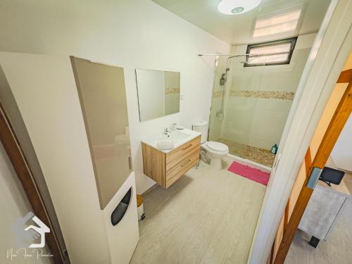 a bathroom with a sink and a toilet and a shower at Airport Pamatai Studio in Faaa