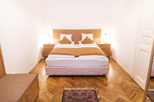a bedroom with a bed and a wooden floor at Authentic Budapest Apartment in Budapest