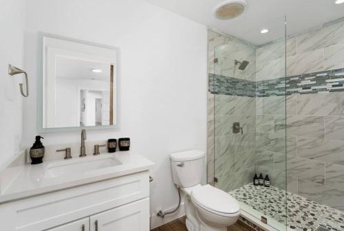 a bathroom with a shower and a toilet and a sink at The Gateway - 6BED W Two Houses GameRoom & Pool in Cedar Park