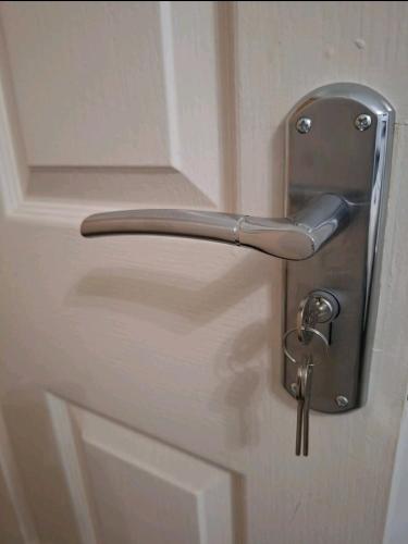 a metal door handle on a white door at Favourite Ensuite Room in Middlesbrough
