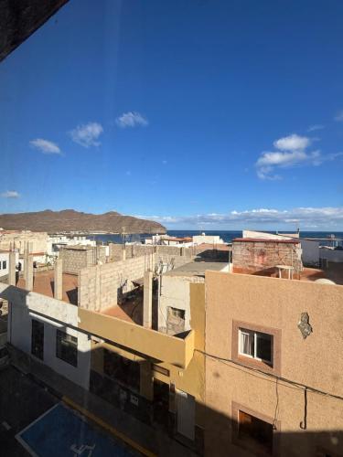 a view of a city from the roof of a building at Room Yu in Gran Tarajal