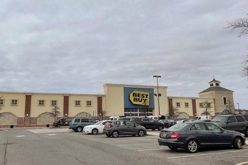 a best buy building with cars parked in a parking lot at Luxury Living at Woodmore in Bowie