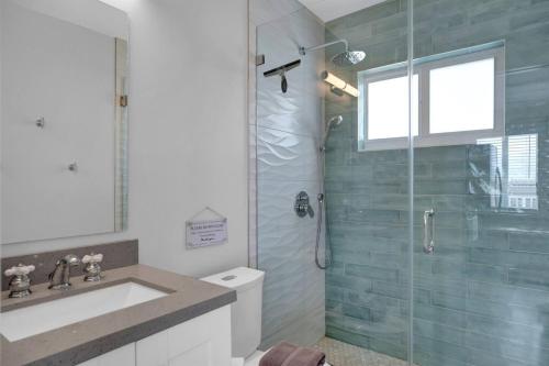 a bathroom with a shower and a sink and a toilet at Waterfront Studio 2, Couples Oasis, Kayaks, Pool in Jewfish