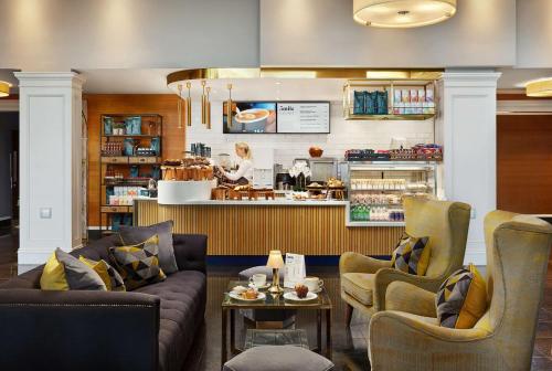 a restaurant with two couches and a counter at Radisson Blu Hotel, Cork in Cork