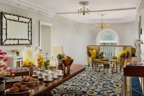 a living room with a table with food on it at Radisson BLU Hotel & Spa, Little Island Cork in Cork