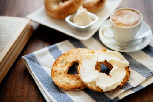 a table with a plate of donuts and a cup of coffee at Sonesta Select Charlotte University Research Park in Charlotte