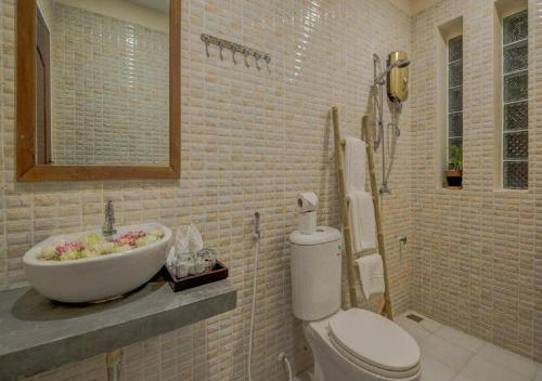 a bathroom with a sink and a toilet and a tub at Punleu Raksmey Boutique in Siem Reap