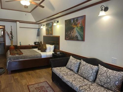 a living room with a bed and a couch at Captain Morgan's Retreat in San Pedro
