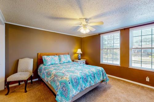 a bedroom with a bed and a ceiling fan at Sandy Feats in Gulf Highlands