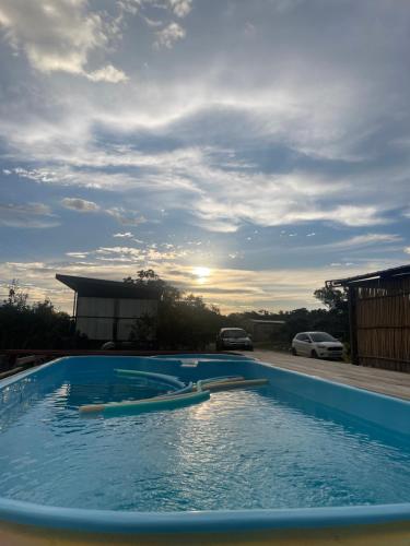 uma piscina com o pôr-do-sol ao fundo em Dolaço na Chapada- Hospedagem em Alto Paraíso de Goiás