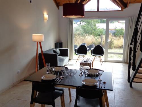 een woonkamer met een eettafel en stoelen bij Casas con vista al Piltri in El Bolsón