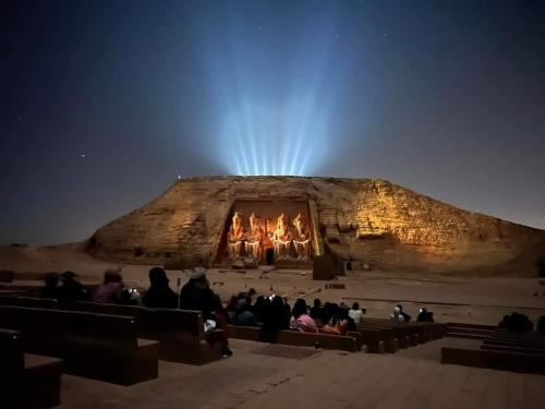 a group of people sitting in front of a fireplace at Erki Guest House in Abu Simbel