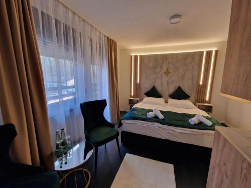 a hotel room with a bed and a window at Lilium Resort Hotel & Restaurant in Bad Rodach