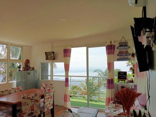 a dining room with a view of the ocean at Cabin de Paulin 1 in Tagaytay