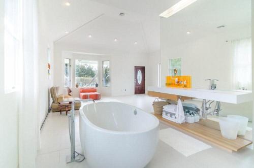 a large white bathroom with a large tub in it at West Hamptons Zen retreat in Westhampton