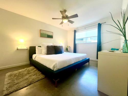 a bedroom with a bed with a ceiling fan at Quiet Haven with Huge Fenced Yard Fast Internet by Lodgewell in Austin