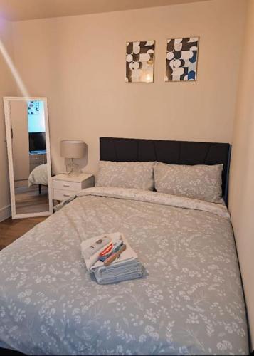 a bed with a pile of towels on top of it at 1-bed flat near Romford station in Romford