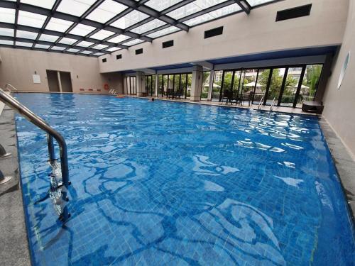 a large swimming pool with blue tiles in a building at The Wonder Bay Halong studio in Ha Long