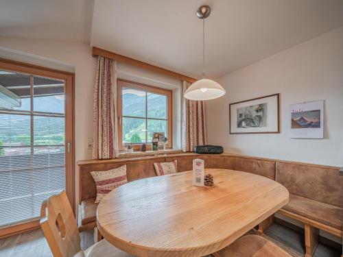 a dining room with a wooden table and chairs at Röck XL in Neukirchen am Großvenediger