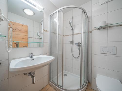 a bathroom with a sink and a shower at Röck XL in Neukirchen am Großvenediger