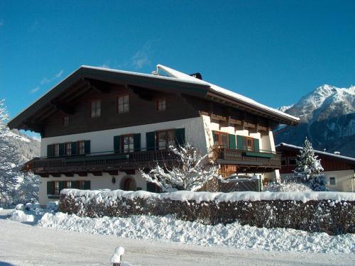 a house with snow on the ground in front of it at Röck IB in Neukirchen am Großvenediger