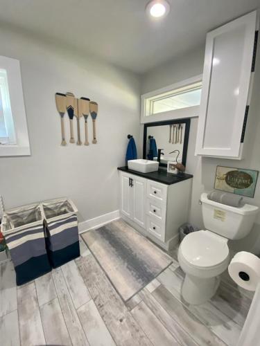 a bathroom with a white toilet and a sink at Sandy Haven in Bolivar Peninsula