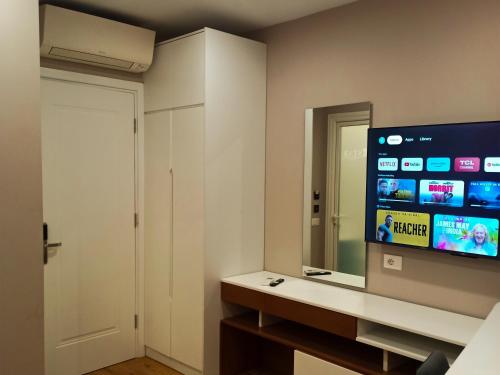 a room with a mirror and a tv in a room at Star Hotel in Tirana