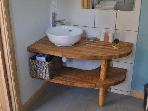 a sink on a wooden table in a bathroom at Majestic apartment in La Vancelle in La Vancelle