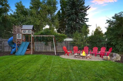 a backyard with a playground with chairs and a fire pit at Shakedown St HOT TUB Fire Pit and 4 Miles to DT in Denver