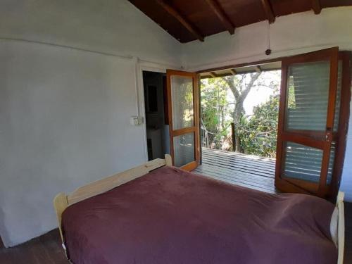 a bedroom with a bed and a large window at Casa Ituzaingo Corrientes in Ituzaingó