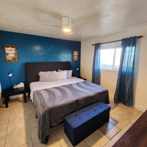 a bedroom with a large bed with a blue wall at *Msg for 5%off*2Bed1Bath KingQueenBeds MidtownPHX in Phoenix
