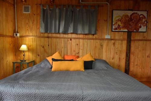 a bedroom with a bed with wooden walls and a window at Remanso in Santa Fe